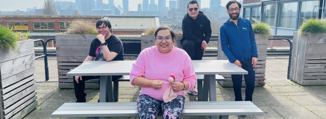 Groepje cliënten van Pameijer Media zitten op het dak en kijken de camera in